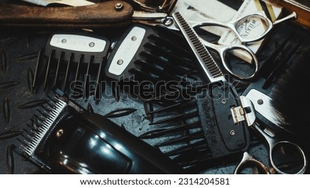 A closeup of Clipper Guards, scissors and hair clippers on the table Royalty-Free Stock Photo #2314204581