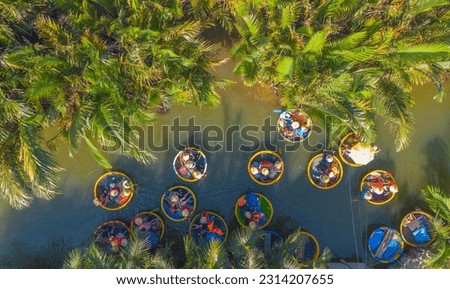 Aerial view of a coconut village basket boat tour. Palms forest in Hoi An, Cam Thanh, Vietnam. Tourists having an excursion and fun in Thu Bon river Royalty-Free Stock Photo #2314207655