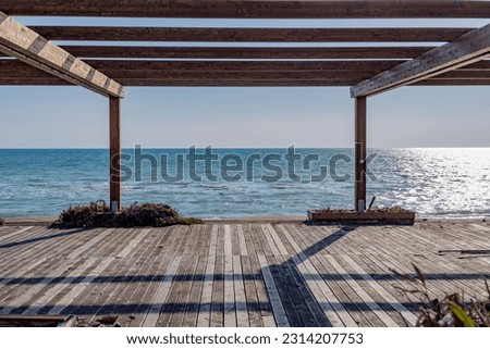 A wooden patio with a view of the ocean
