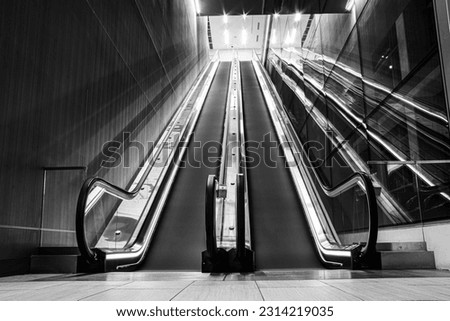 a grayscale shot of escalators Royalty-Free Stock Photo #2314219035