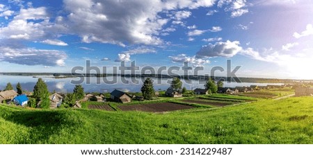 View from the hill to Lake Kenozero in the village of Vershinino. Kenozersky National Park. Plesetsky district. Arkhangelsk region. Russia. High-resolution panorama. Bright summer photo