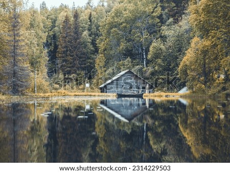 An old grain mill or watermill through a mill pond in autumn in Kenozersky National Park, Arkhangelsk Oblast, Russia. 