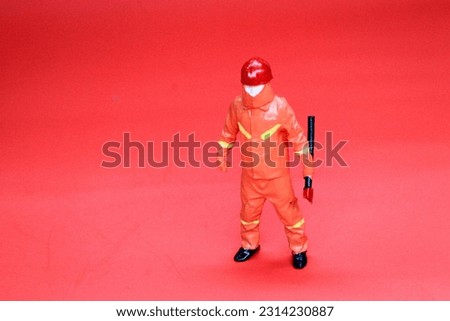 model Fireman fireman with ax on red background, Rescue fireman, Fireman wearing full equipment