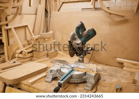 close up of a carpenter screwed a hinge on a wooden plank. Royalty-Free Stock Photo #2314243665