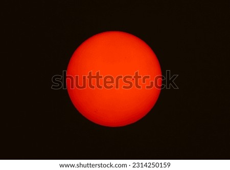 Sunspots on the sun seen due to forest fires taken 6th June 2023 in Ottawa, Canada against a black background. Royalty-Free Stock Photo #2314250159