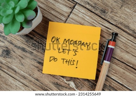 Concept of OK Monday Let's Do This! write on sticky notes isolated on Wooden Table.