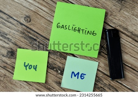 Concept of Gaslighting You and Me write on sticky notes isolated on Wooden Table. Royalty-Free Stock Photo #2314255665