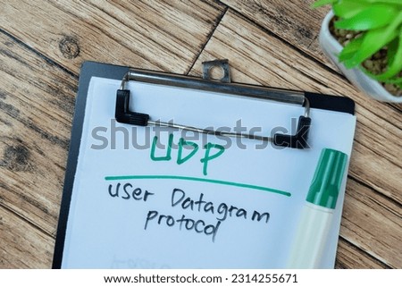 Concept of UDP - User Datagram Protocol write on paperwork isolated on Wooden Table.