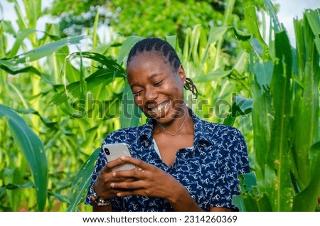 female african farmer using her phone Royalty-Free Stock Photo #2314260369