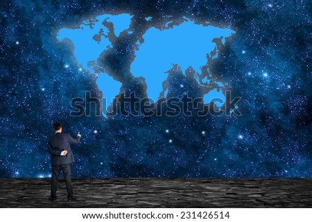 Businessman sitting on the Moon and using a laptop with Earth in the background "Elements of this image furnished by NASA" 