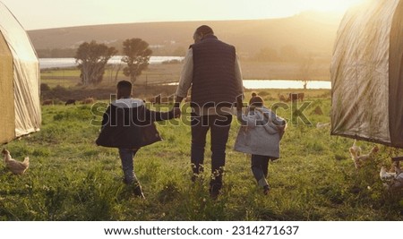 Family, holding hands and a man walking on a farm with his kids for agriculture or sustainability. Back, farming and a father with children in meadow as a cow farmer in natural countryside at sunset Royalty-Free Stock Photo #2314271637