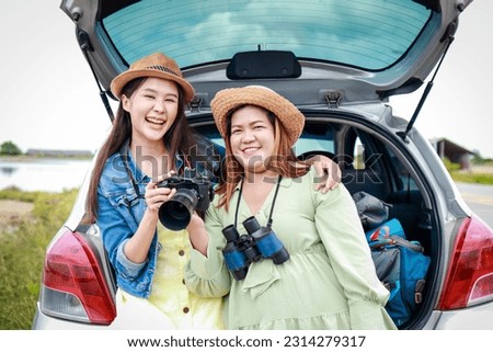 Portrait of two Asian women traveling by private car. Transport concept, tourism. Asian tourists