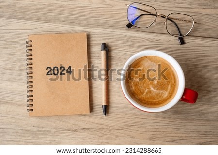 2024 notebook and coffee cup on wood table, Top view and copy space. Xmas, Happy New Year, Goals, Resolution, To do list, Strategy and Plan concept