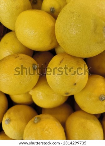Lemon is yellow, tart, sweet, and delicious when made into a drink with ice.