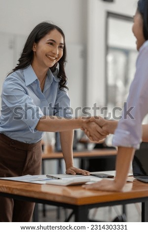 Two businesswoman shaking hands for success. Handshake. Collaboration, teamwork, friendship. Meeting of financial business partners, paperwork, calculations, investments, company partnerships. Royalty-Free Stock Photo #2314303331