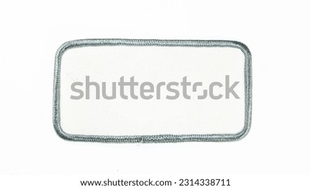 White rectangular patch with silver trim and rounded corners. Royalty-Free Stock Photo #2314338711