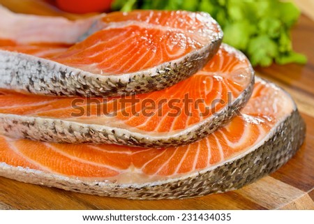 Delicious  portion of fresh salmon fillet  with aromatic herbs, spices and vegetables