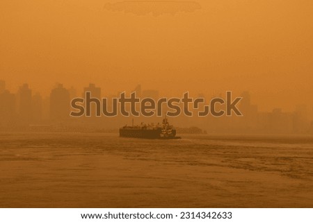 Barge Boat on the East River in New York City with Massive Air Pollution from Wildfires Royalty-Free Stock Photo #2314342633