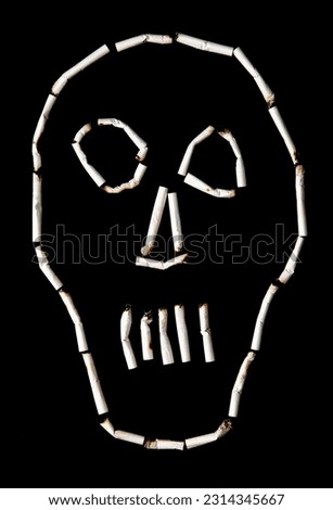 the outline of a human skull made of cigarette butts on a black background. Image representing the toxicity of tobacco for health