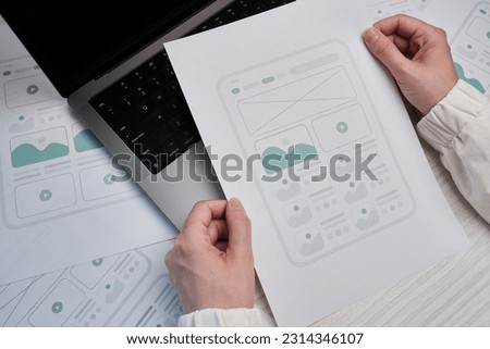 Woman designer create website design wireframe. Sketch, prototype, framework, layout future design project. UI and UX - user interface, user experience designer. Creative concept for web design studio Royalty-Free Stock Photo #2314346107