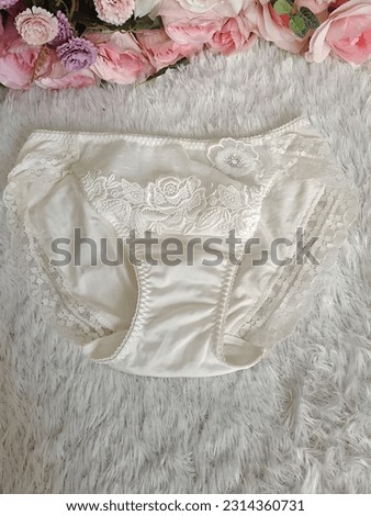woman white lace panties with flower brocade for motif. top view