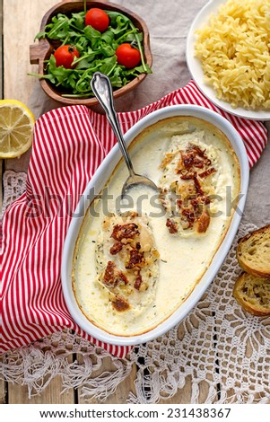Chicken breasts baked in creamy sauce with pasta. Selective focus