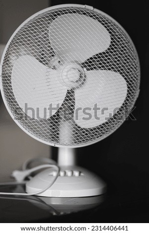 White fan on black background