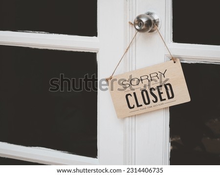 Closed in a cafe or restaurant hanging at the entrance. vintage black retro sign in glass door storefront.       