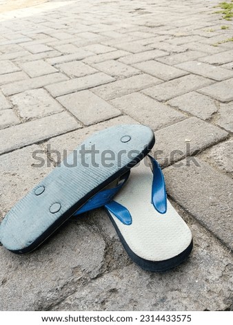 Someone left his flip-flops on the street. Old flip-flops thrown out on the street. Empty space for text