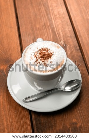 Cup of classic italian cappuccino with cocoa powder 