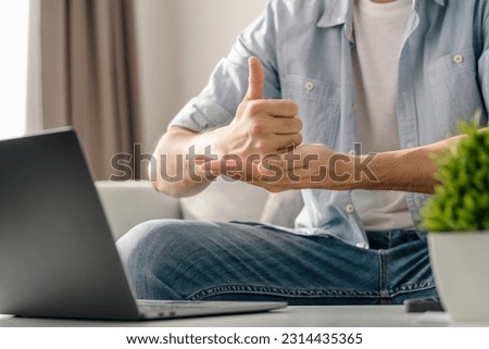 Young deaf man using laptop computer for online video conference call learning and communicating in sign language. Royalty-Free Stock Photo #2314435365
