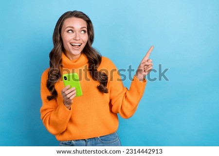 Photo of millennial blogger lady using gadget pointing empty space demonstrate online offer isolated on blue color background