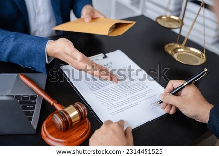Legal counsel presents to the client a signed contract with legal law. justice and lawyer concept in office.
