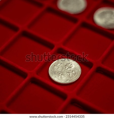 Collection of coins. Italian lira, close-up, lira on a red background. coin close up