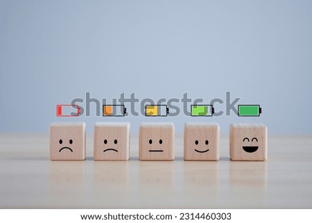 Level of low battery with sadness face to full battery with happy smile face. Energy life, Emotion Level, World mental health day, Passion, Happy Life, Satisfaction, Full energy and Positive thinking. Royalty-Free Stock Photo #2314460303