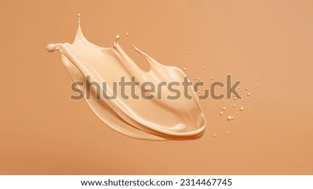 Liquid foundation splashing on light clean background, Close-up of isolated make-up smudges or beige skin care fluid Royalty-Free Stock Photo #2314467745