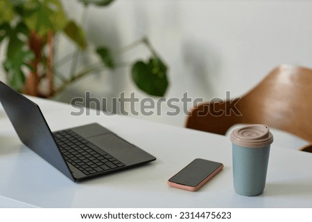 Closeup background image of simple workplace with open laptop on desk, copy space