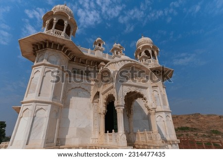 Beautiful architecture of Jaswant Thada cenotaph, Jodhpur, Rajasthan,India. in memory of Maharaja Jaswant Singh II. Makrana marble emitting warm glow when illuminated by the Sun. Blue sky background.