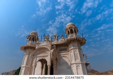 Beautiful architecture of Jaswant Thada cenotaph, Jodhpur, Rajasthan,India. in memory of Maharaja Jaswant Singh II. Makrana marble emitting warm glow when illuminated by the Sun. Blue sky background.