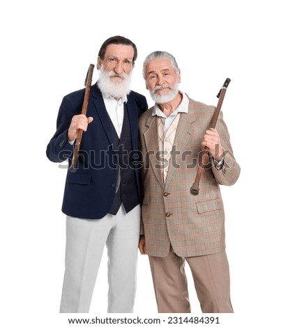 Senior men with walking canes on white background