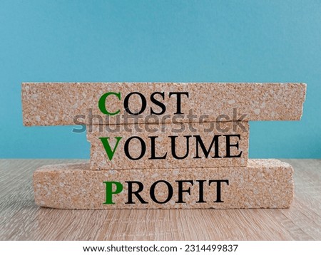 CVP cost volume profit symbol. Concept green words CVP cost volume profit on brick blocks on a beautiful wooden table blue background. Business and CVP cost volume profit concept. Copy space.