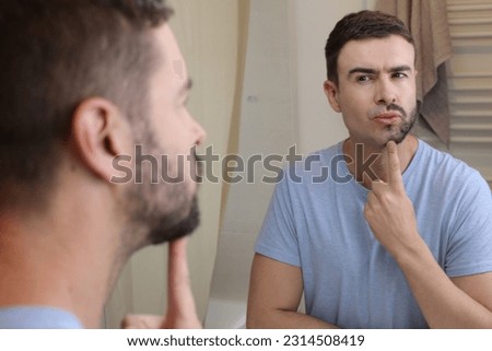Man with only half of his facial hair  Royalty-Free Stock Photo #2314508419