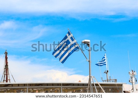 Greece national flag on top a nautical sales boat docked in Rhodes, Greece 