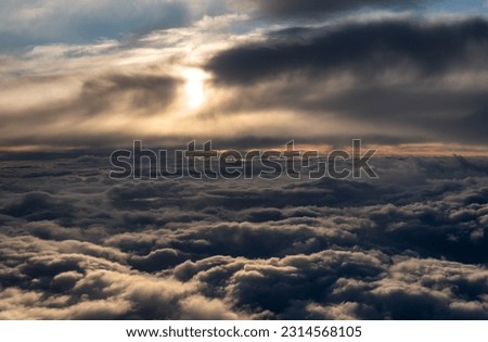 view from the window of the plane landscape over the clouds colored background
