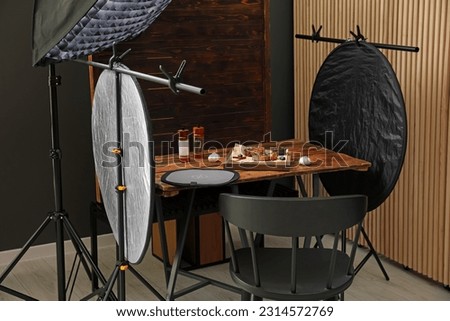 Professional equipment and composition with delicious meat medallions on wooden table in studio. Food photography