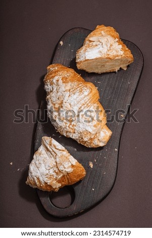 Good morning concept. Fresh croissants with cream filling and almond flakes. Sweet dessert, deconstruction, selective focus, flat lay, top view