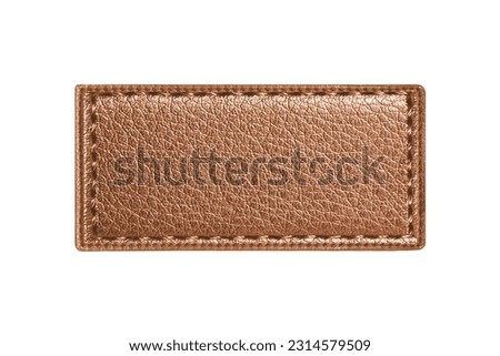 Brown leather belt strap closeup isolated on white. Brown stitched leather seam frame label tag isolated on white. Empty copy space fashion background. Textile frame cutout.  Royalty-Free Stock Photo #2314579509