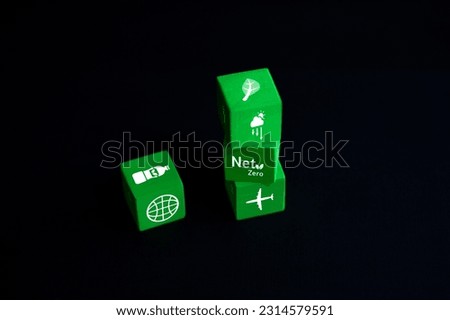 Set of green wooden cubes with eco icons Concept of clean energy conservation and global environment placed on table on black background.