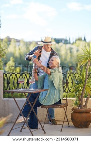 Happy, retired senior couple waving, video chatting with smart phone on summer balcony, enjoying vacation getaway Royalty-Free Stock Photo #2314580371