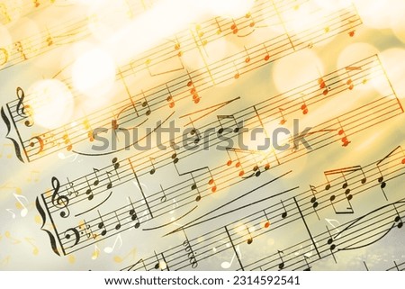 Sheet with music notes as background, closeup. Bokeh effect Royalty-Free Stock Photo #2314592541